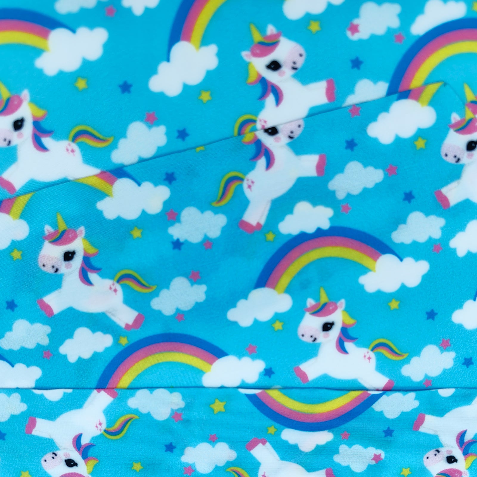 Close-up of unicorn and rainbow fabric strap for kids swim goggles