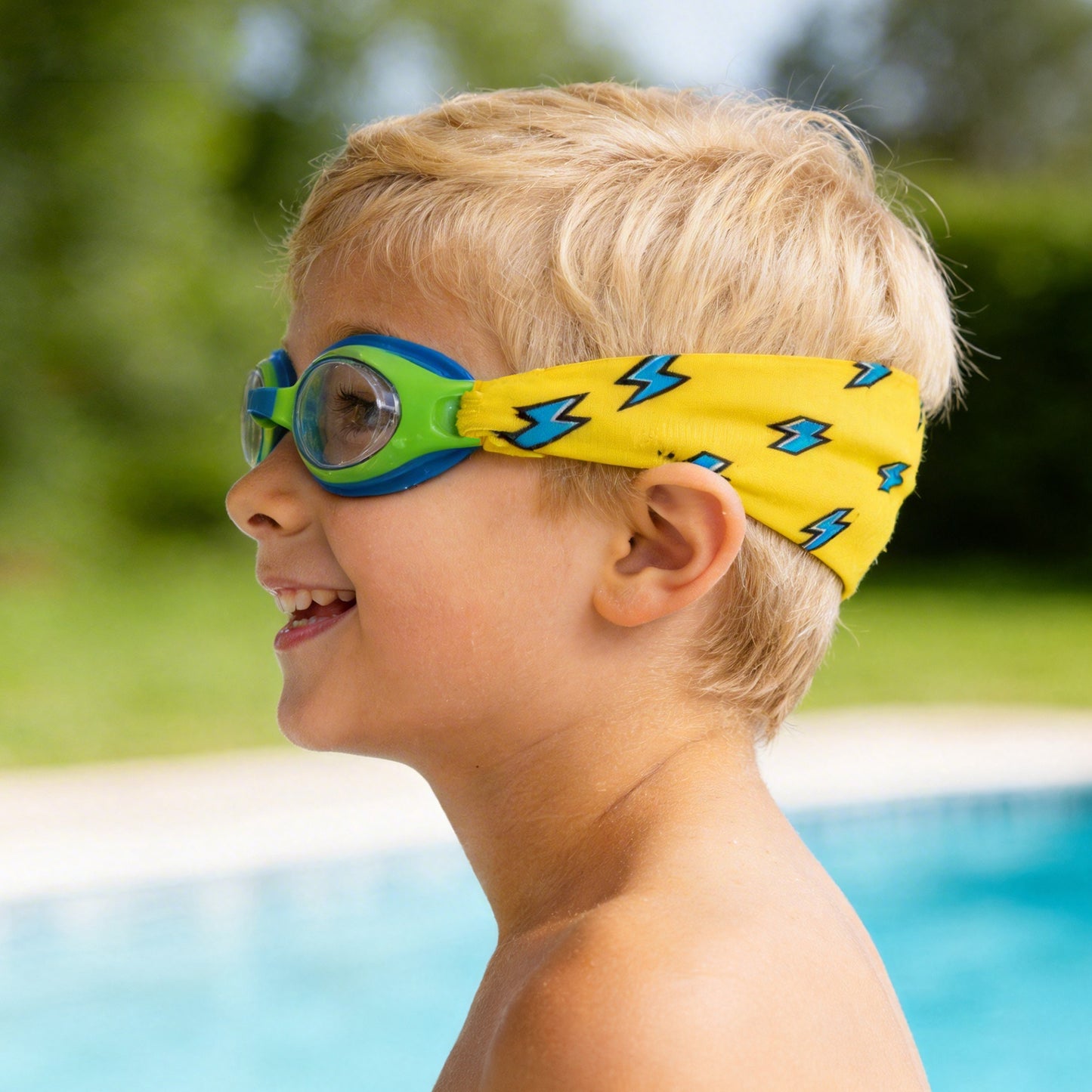 Side view of kids swim goggles with soft fabric strap that prevents hair pulling