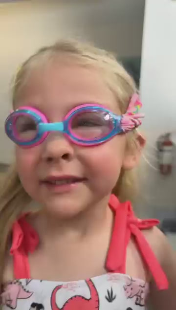 Load video: kid wearing fabric strap goggles by the pool