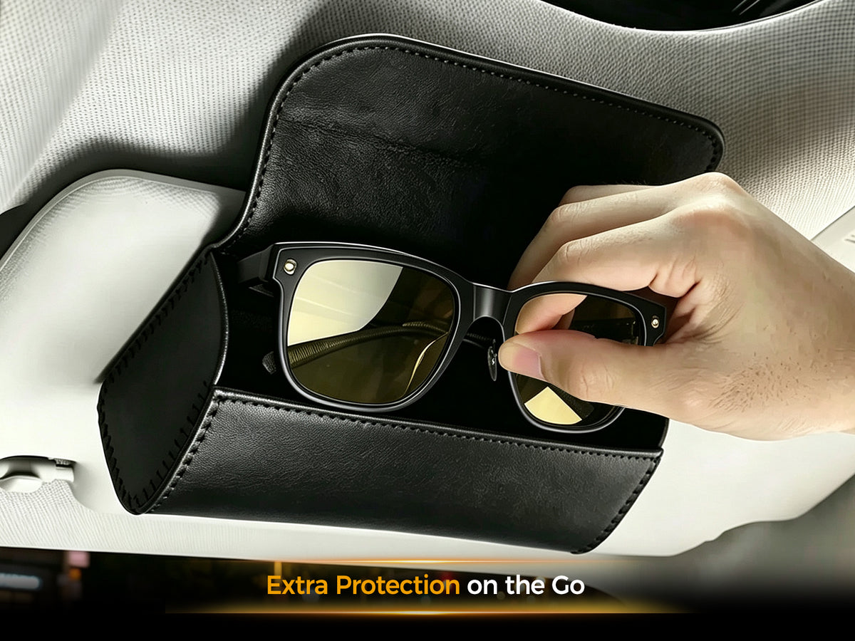 Fit-over night driving glasses placed inside a protective storage box attached to a car sun visor