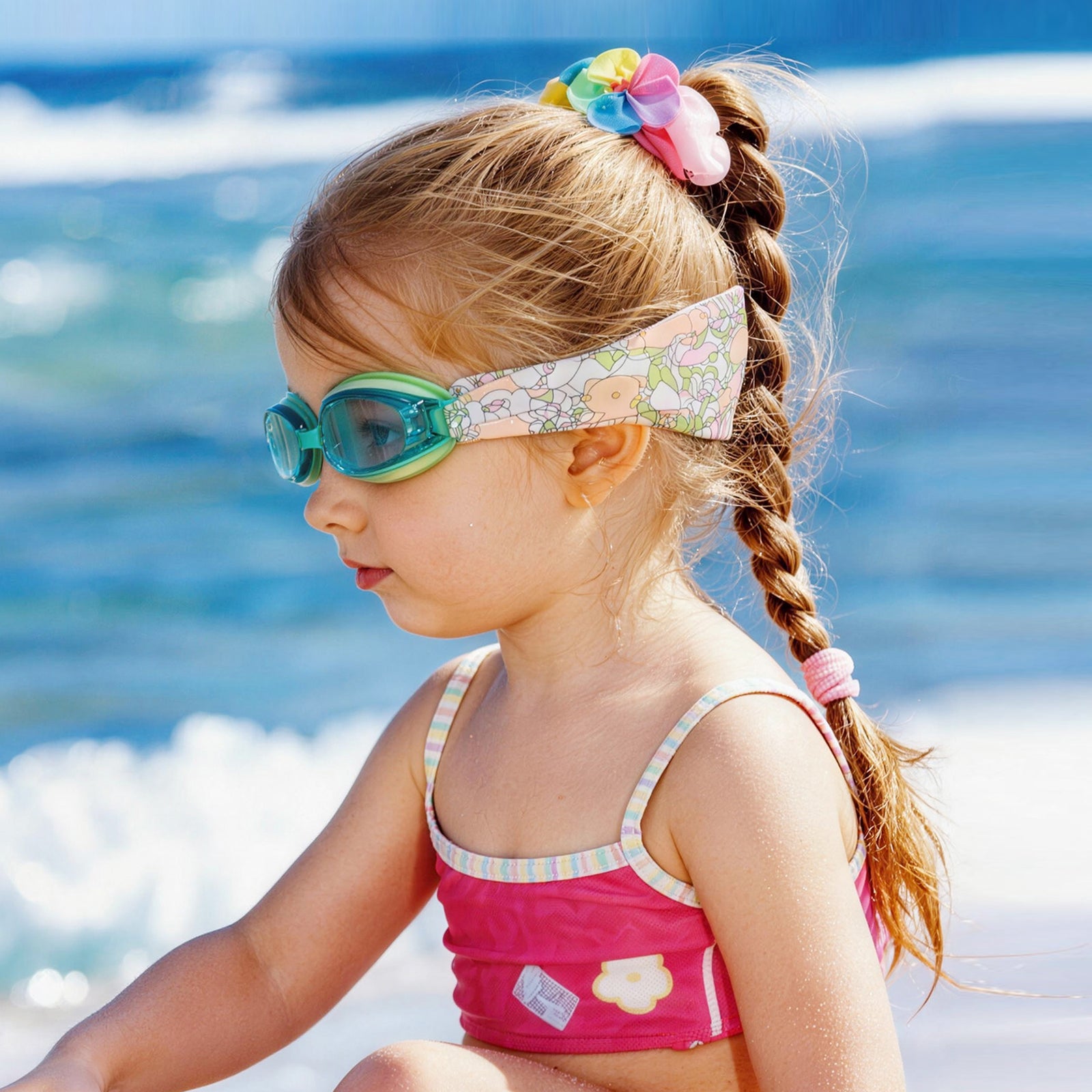 Side view of kids swim goggles with soft fabric strap that prevents hair pulling