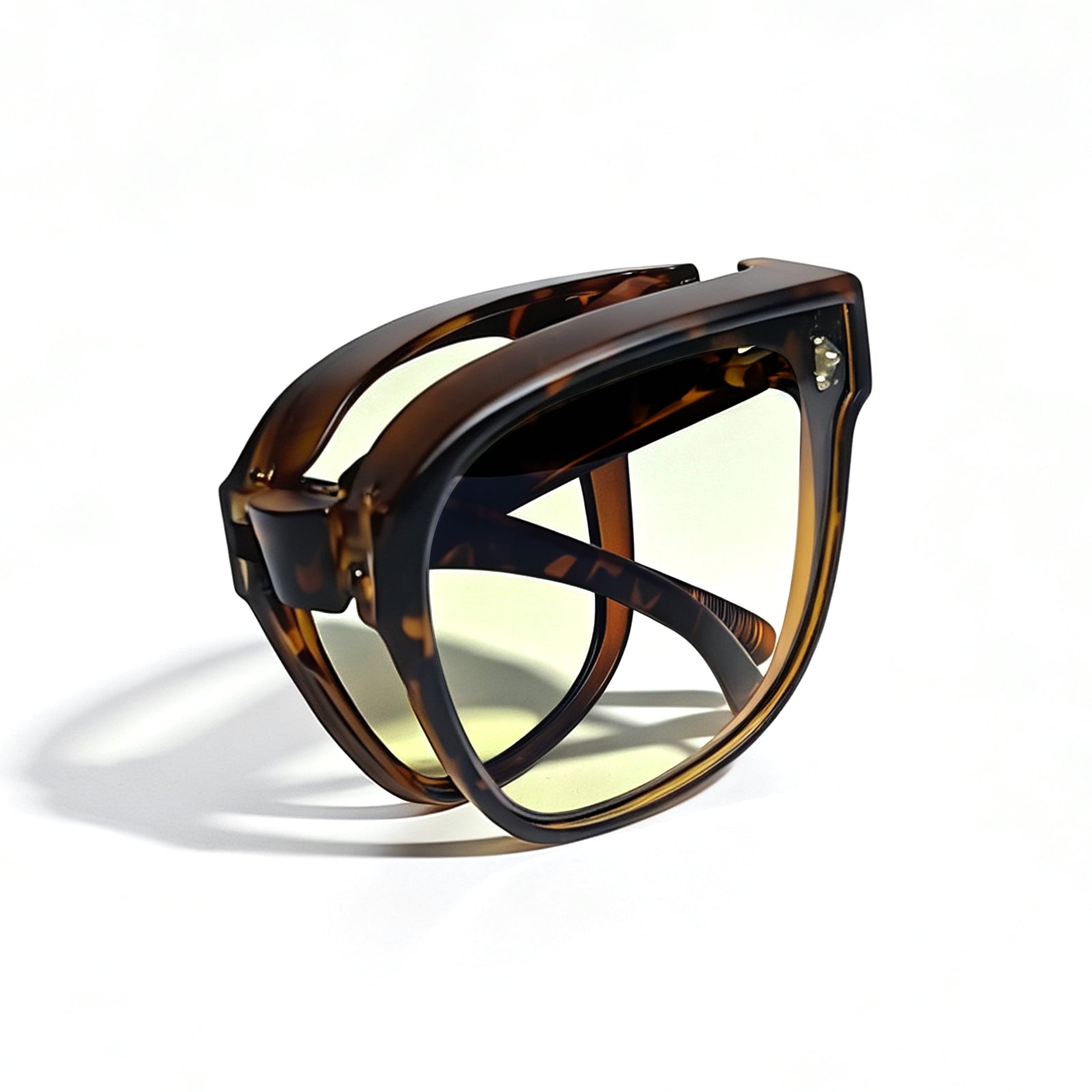 Tortoiseshell fit-over night driving glasses with yellow-tinted lenses, fully folded to show the compact foldable temple design.
