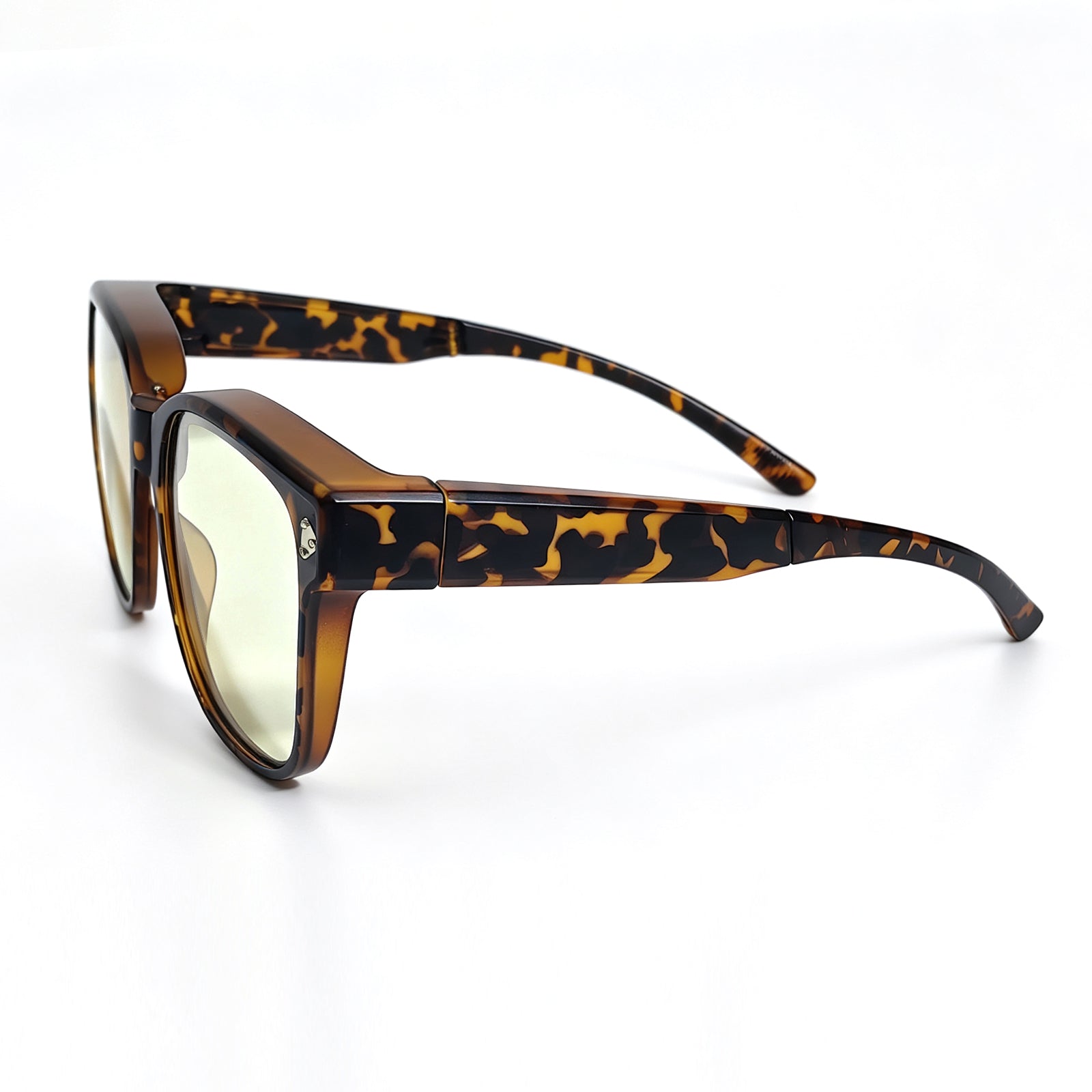 Tortoiseshell fit-over night driving glasses with yellow-tinted lenses, shown from a side angle with the temples fully extended.
